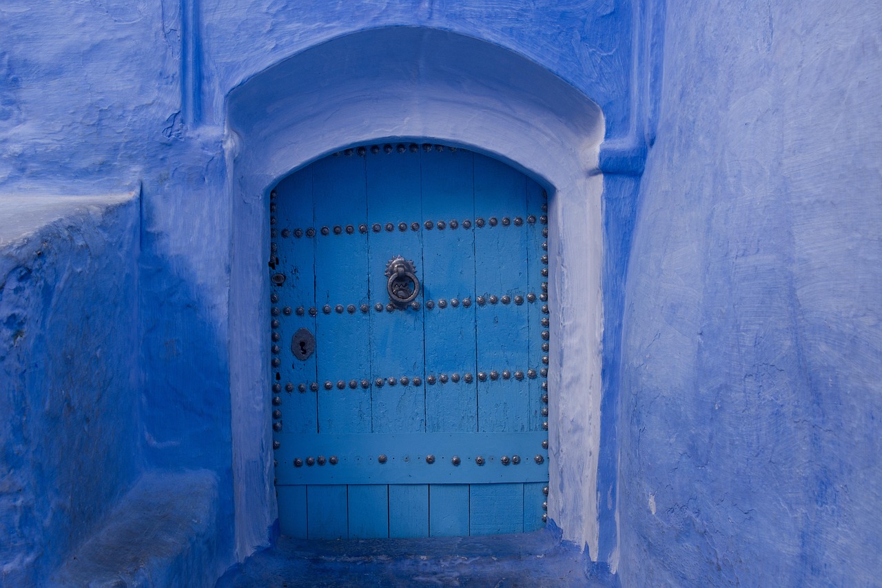 An ornate, ancient hand-carved wooden door in the narrow streets of Stone Town, Zanzibar.