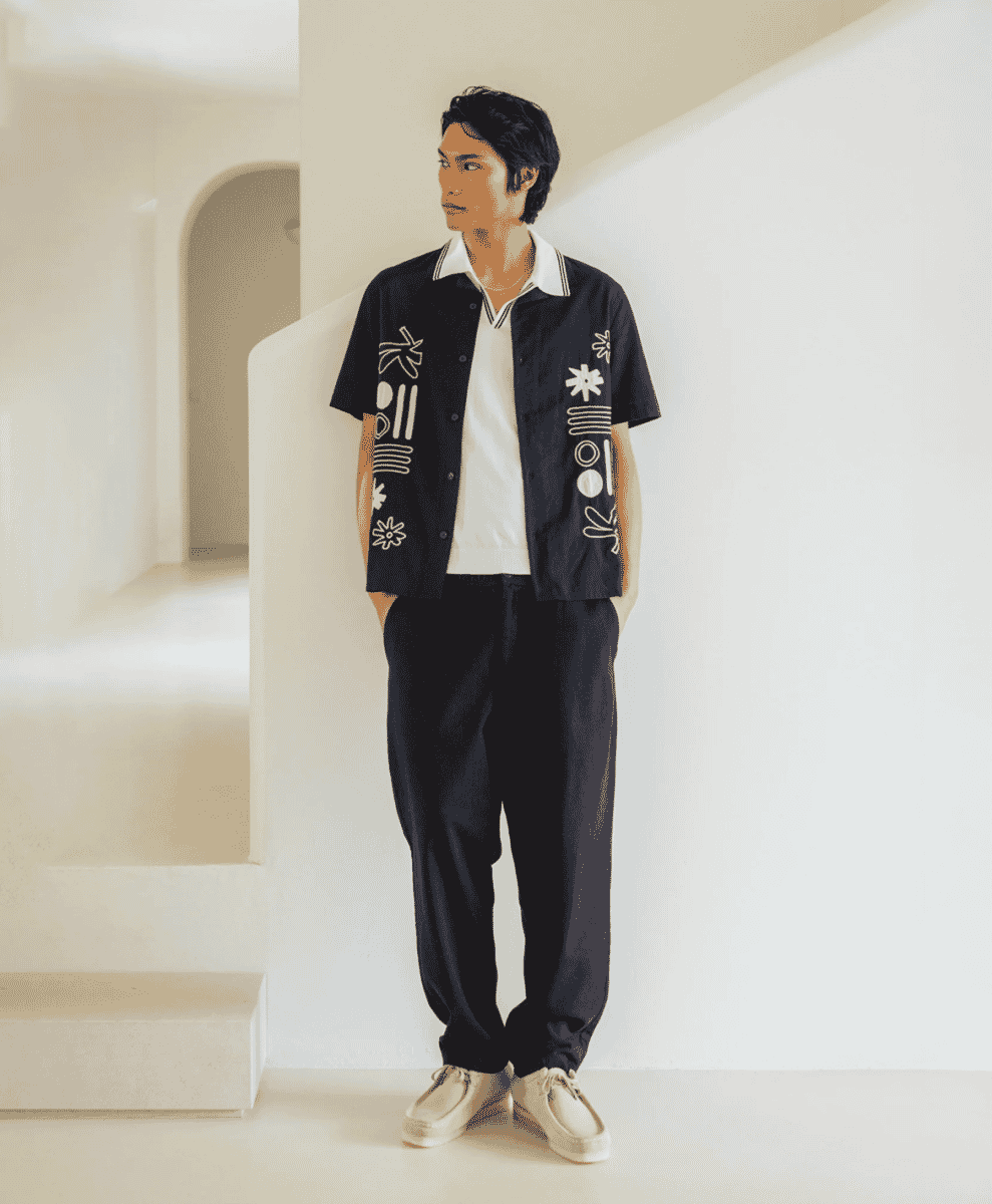 A modern gentleman's modular travel outfit featuring a lightweight overshirt and tailored chinos.