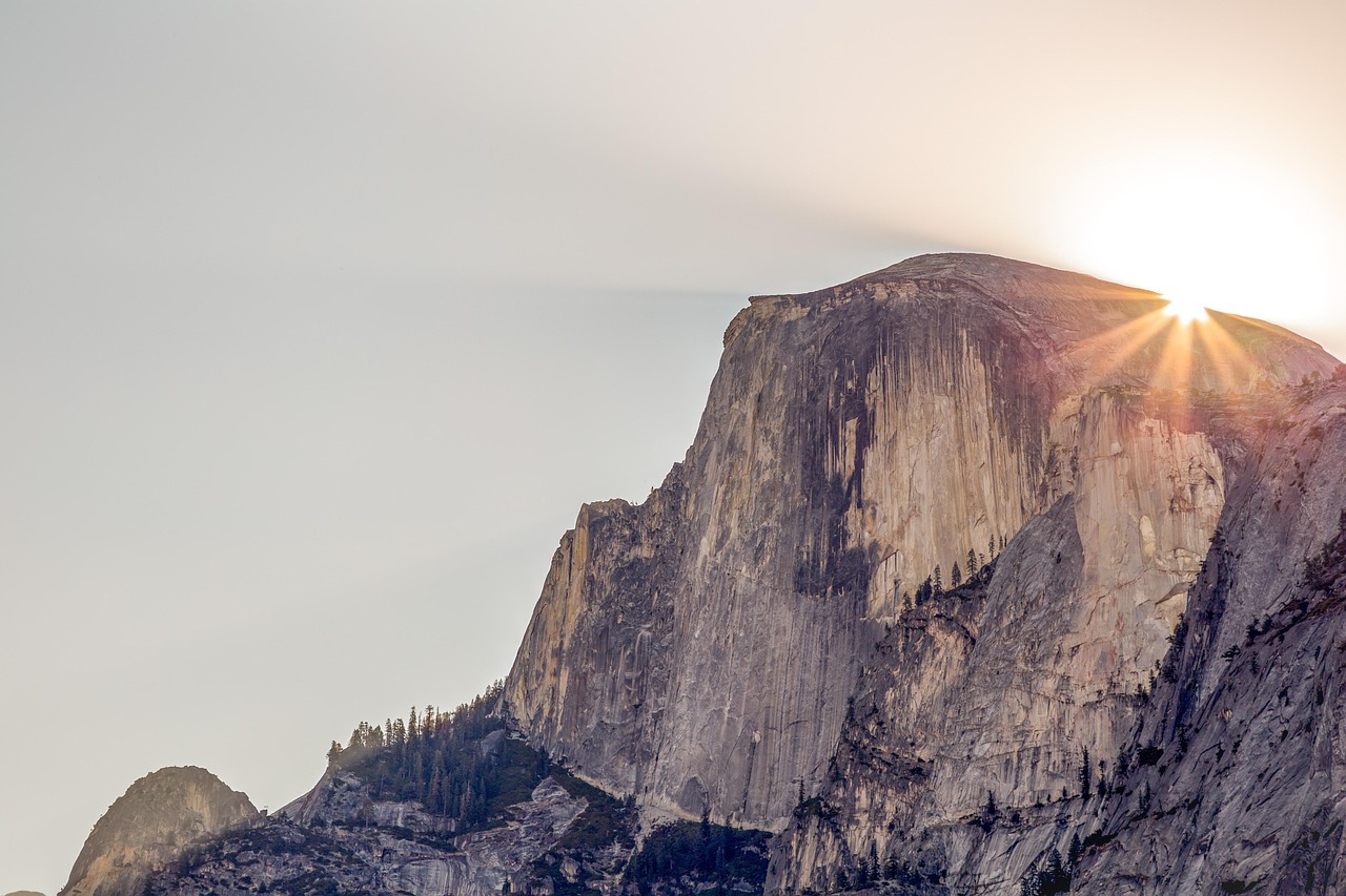 Hikers ascending the steep granite cables of Half Dome