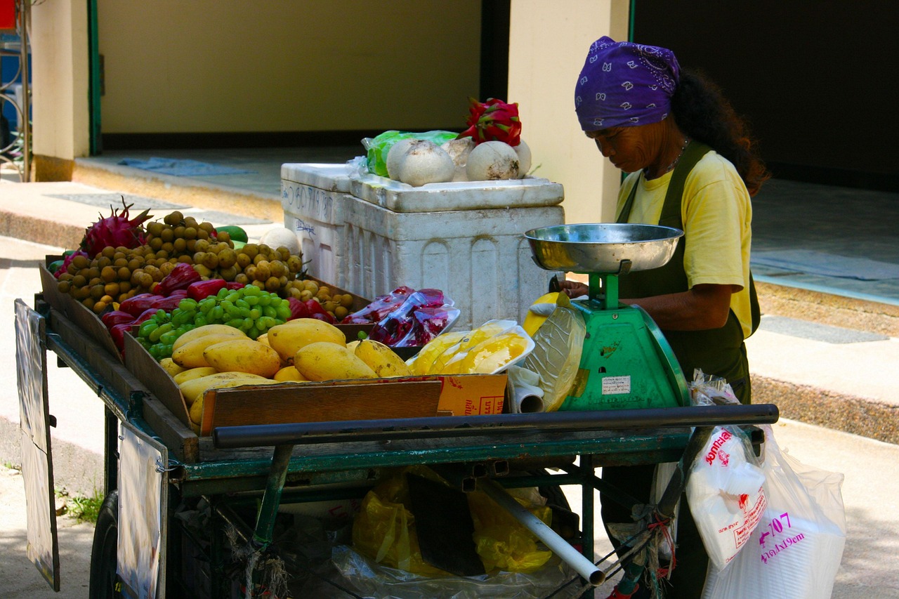 People browsing local handmade goods at an outdoor sunny market