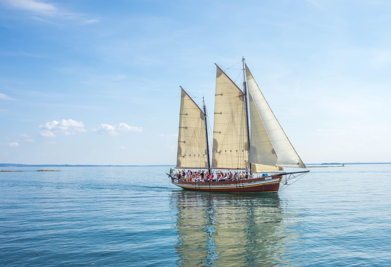 A small zodiac boat carrying passengers toward a remote tropical island.