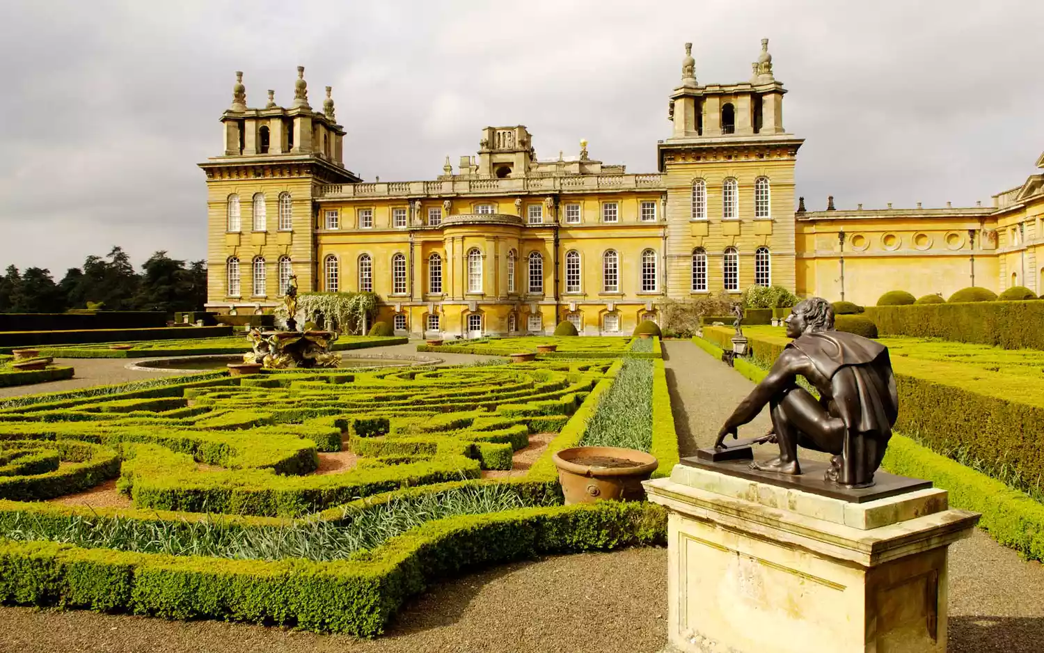 The grand Baroque facade and sprawling courtyard of Blenheim Palace in Oxfordshire.