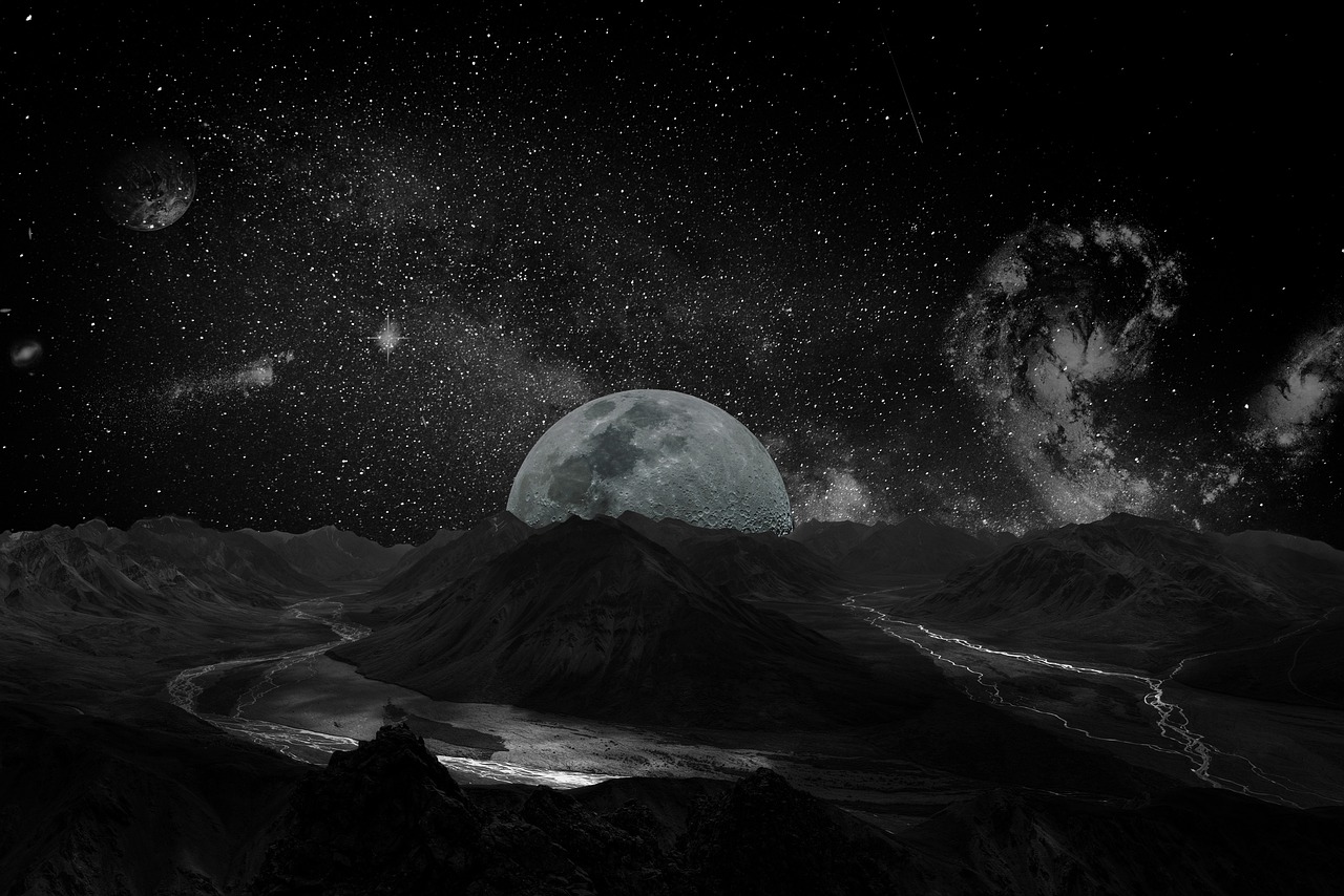 The Milky Way galaxy shining brightly over the dark silhouettes of mountain peaks.