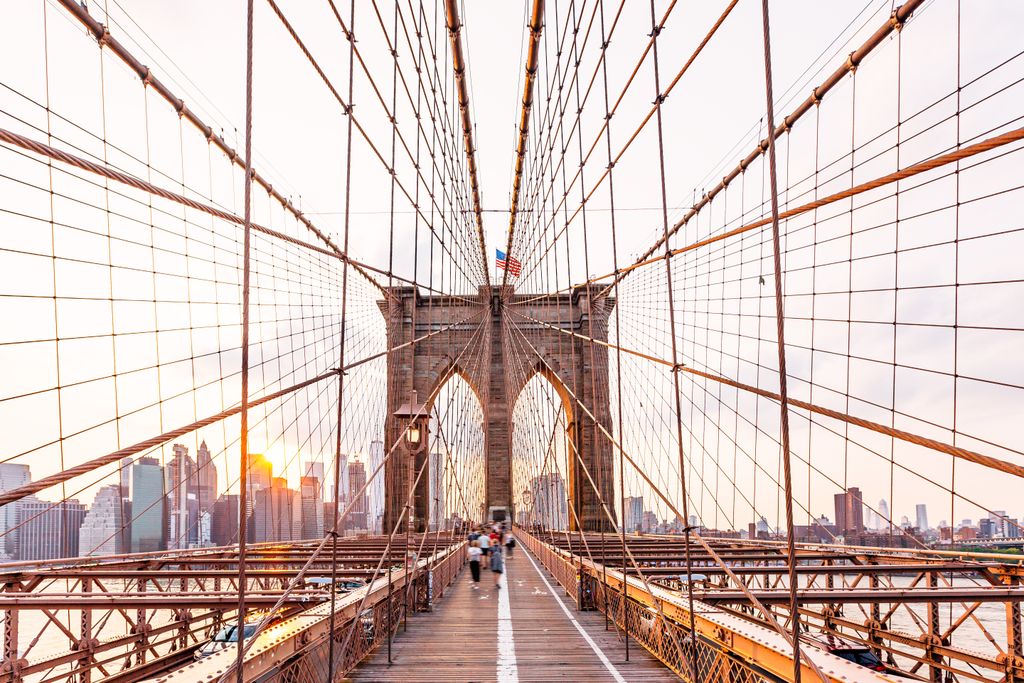 The Manhattan skyline and Brooklyn Bridge at sunset in New York City.