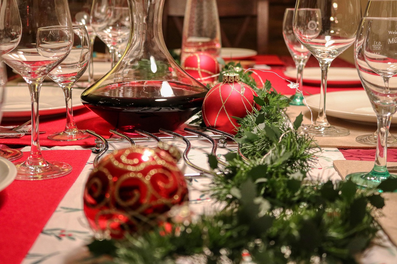 Four glasses of red and white wine arranged on a wooden tasting flight board