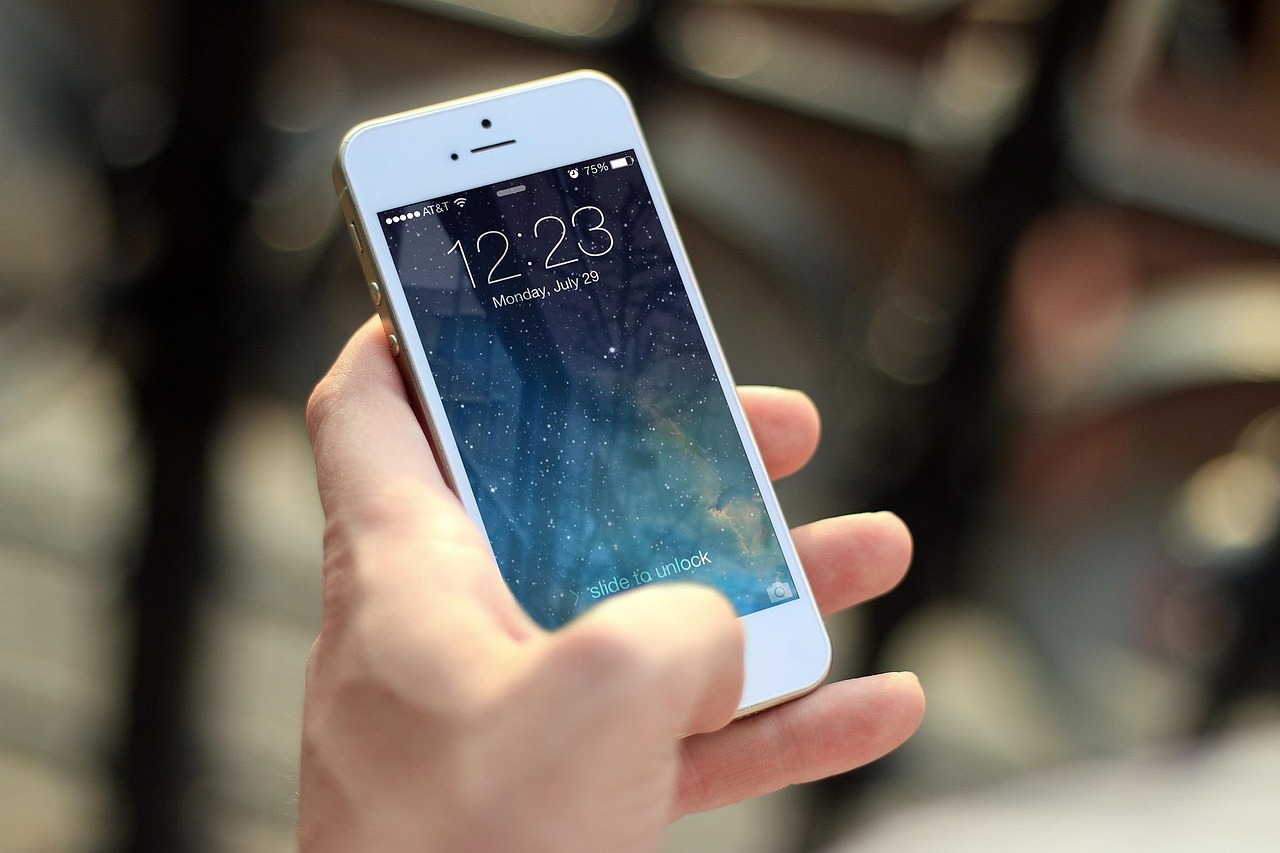 A person holding a smartphone and a premium credit card while planning a trip.