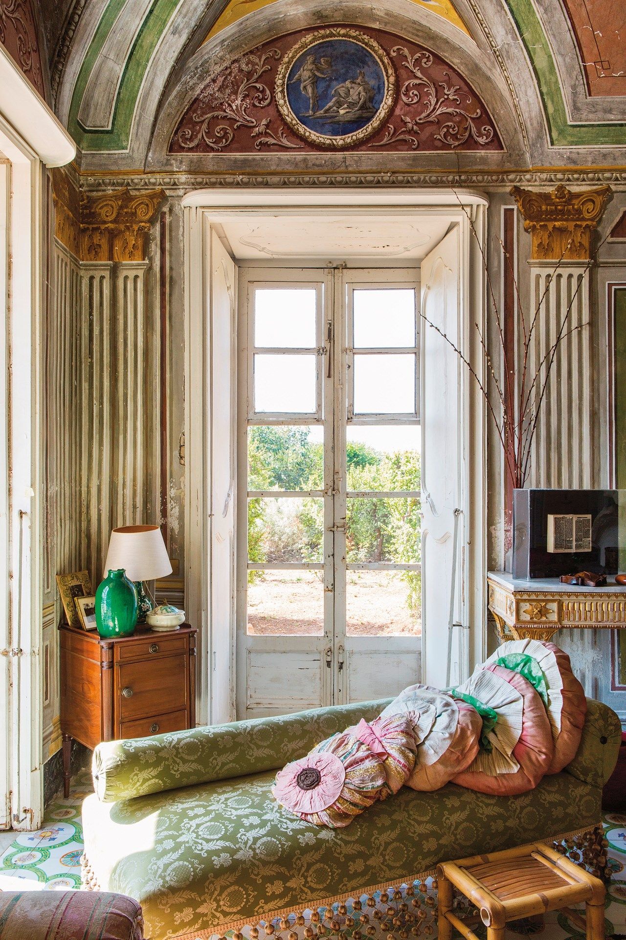 Architectural detail of a grand door and window at Villa Valguarnera.