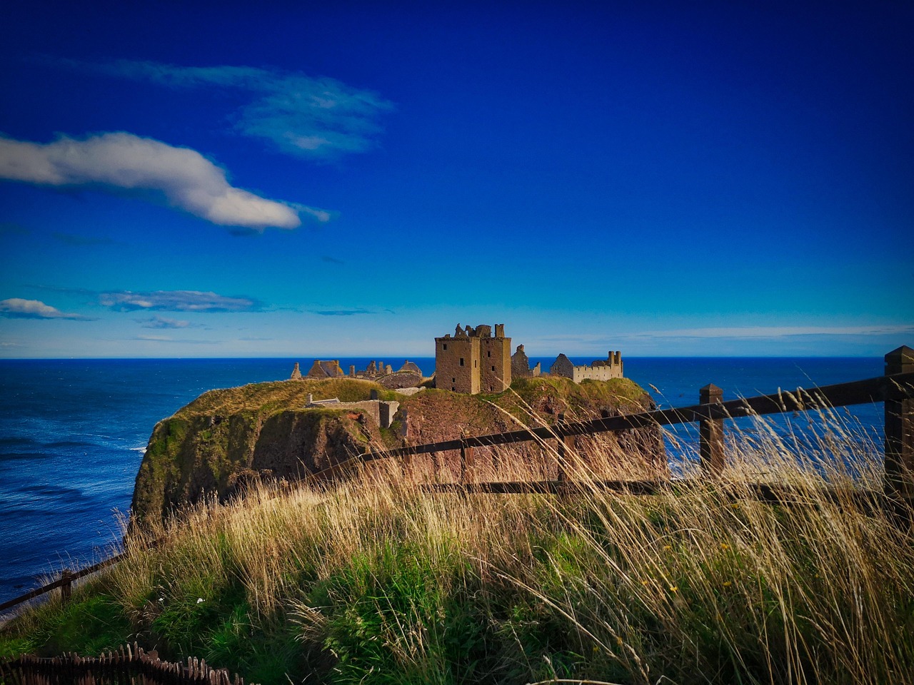 A historic circular stone fortress situated on a small island in the sea