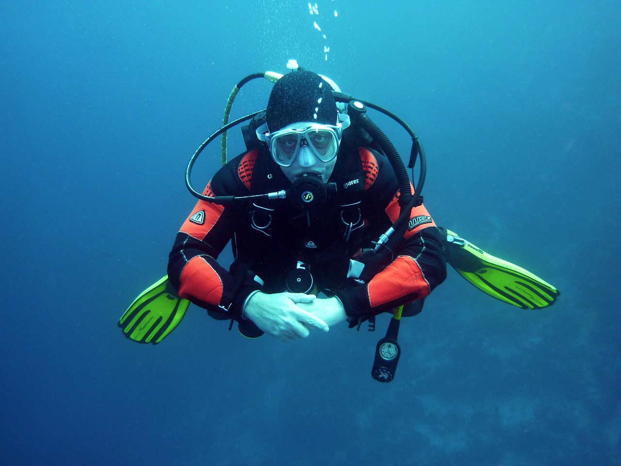A scuba diver collecting discarded fishing nets and plastic from the seabed.