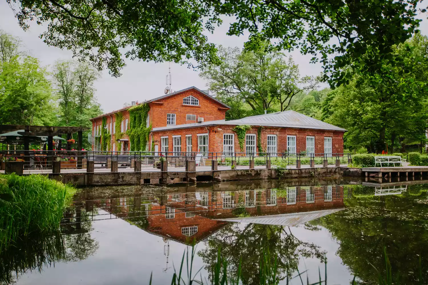 Traditional brick buildings and serene riverside setting in Fiskars Village.