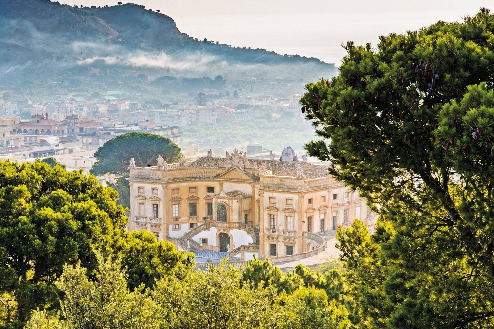 Wide shot of the Villa Valguarnera architecture showing its 18th-century Baroque influence.