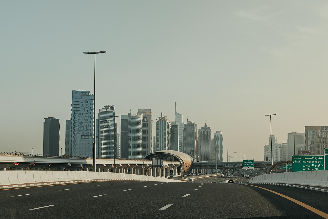 A woman standing in a modern, clean Dubai metro station