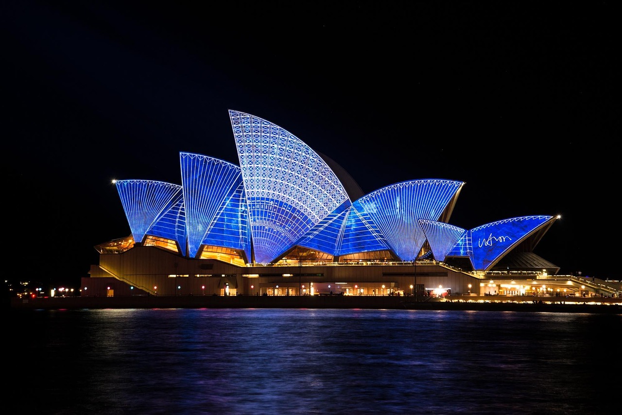 Fireworks exploding over the Sydney Opera House and Harbour Bridge.