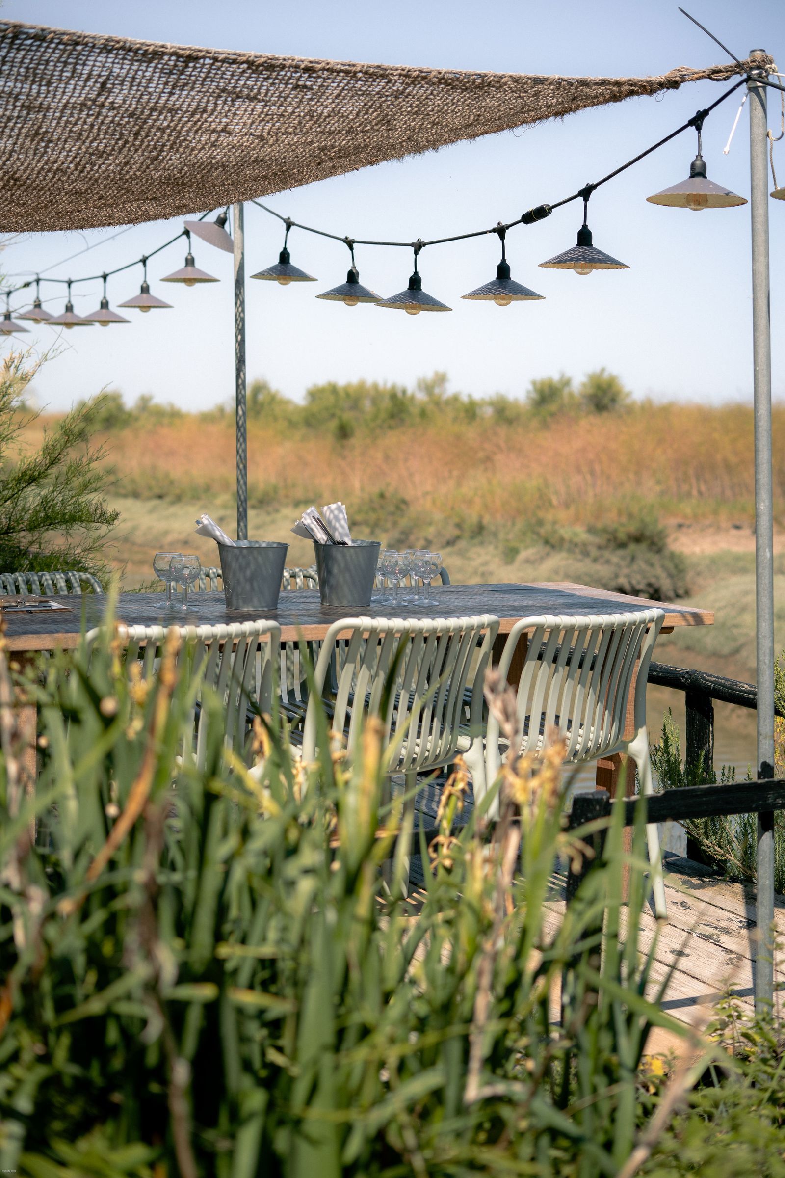 A relaxed outdoor patio setup with wooden furniture in a private terrace.