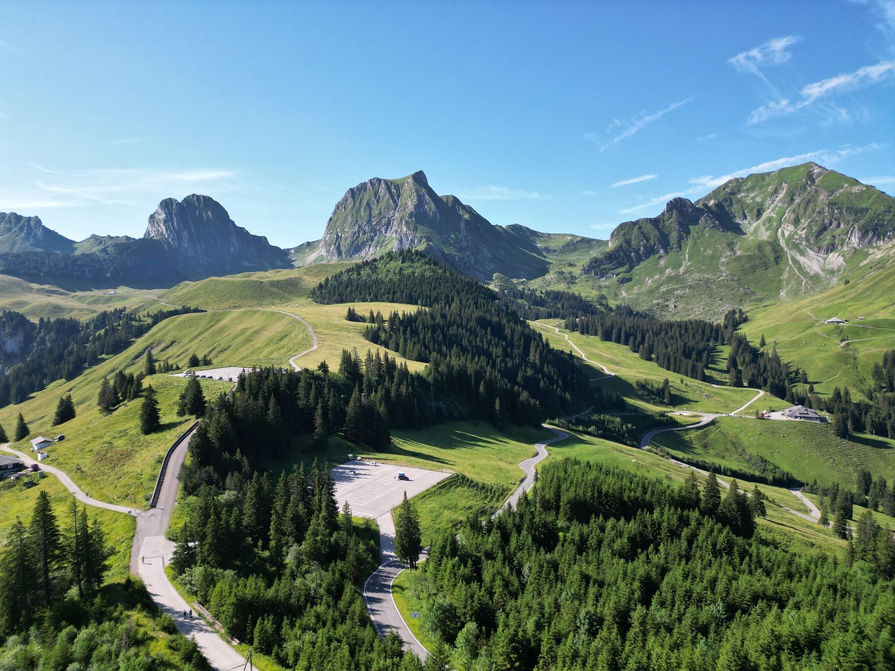 A stunning high-resolution aerial photograph of a winding mountain road.