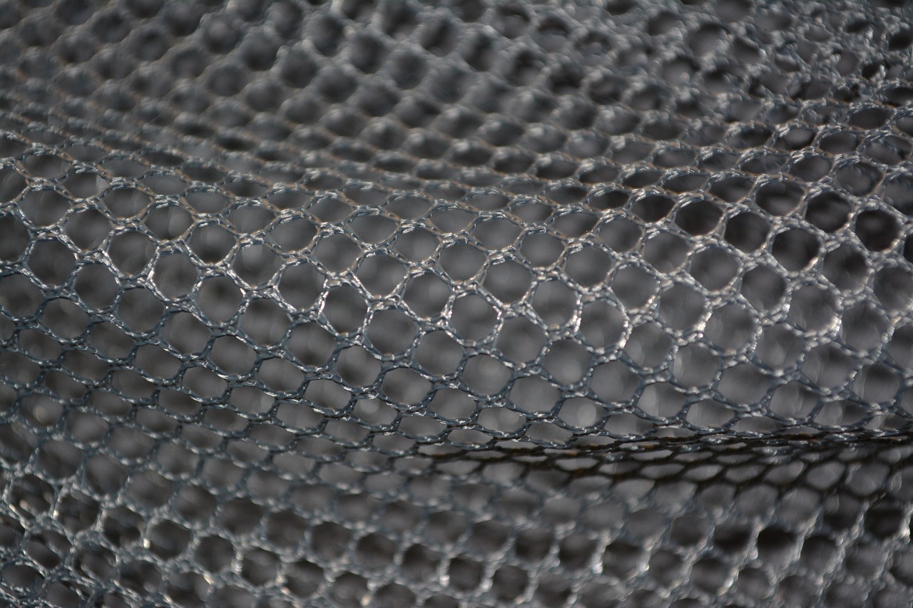 Detailed shot of breathable mesh ventilation holes on a technical fabric.