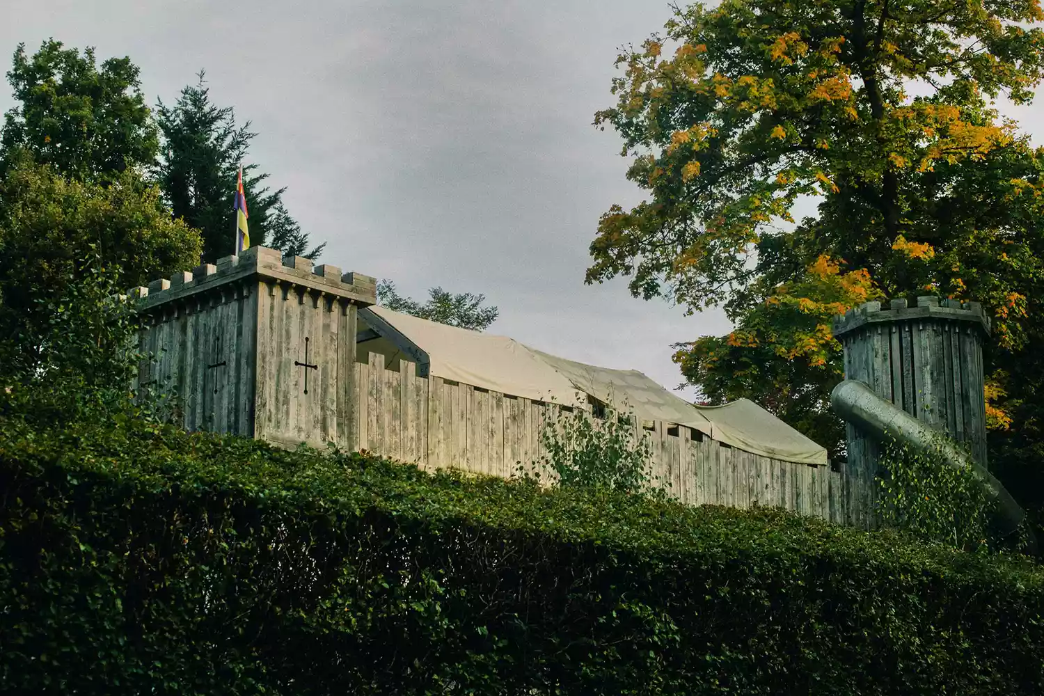 The exterior facade of the double-moated Hever Castle surrounded by lush greenery.