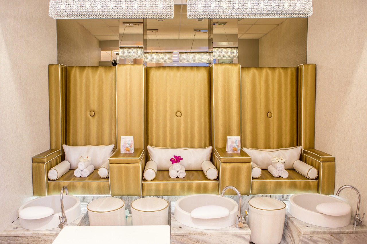 A clean, elegantly decorated massage room with fresh towels, candles, and soft lighting.