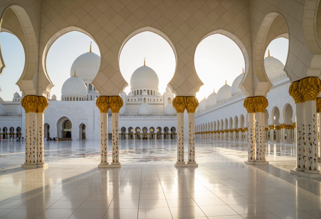The Sheikh Zayed Grand Mosque in Abu Dhabi with its intricate white marble domes.