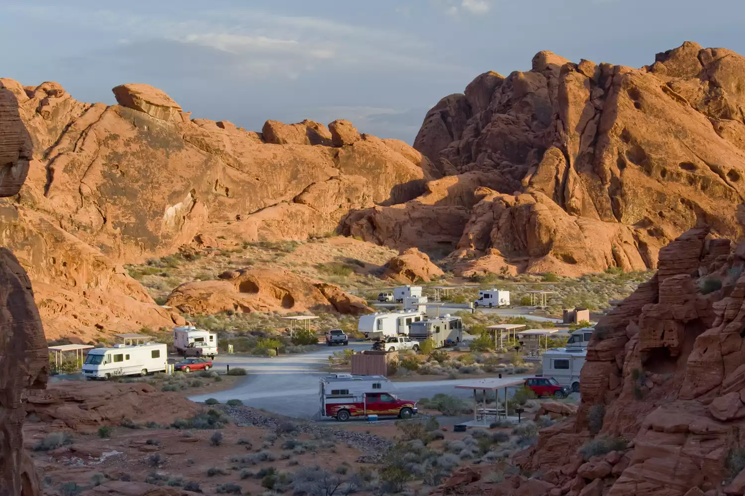 A desert campground nested among vibrant orange and red sandstone rock formations in Nevada.