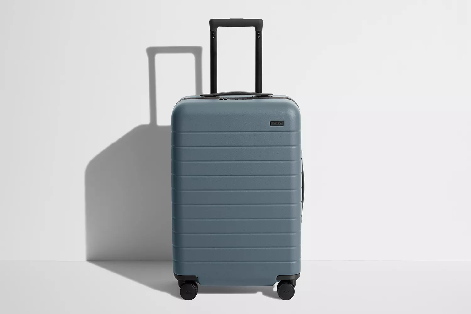 The Away Bigger Carry-On suitcase in a neutral setting.