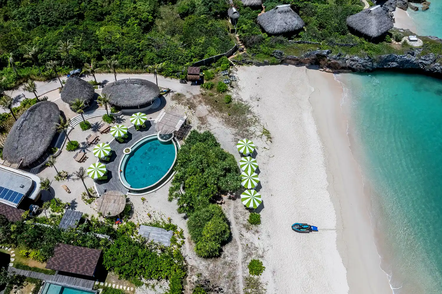 Aerial view of a luxury eco-resort on Rote Island featuring infinity pools and beachfront villas.