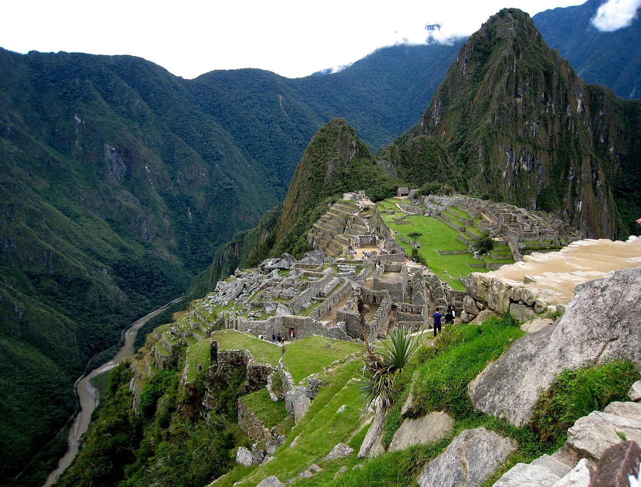 The ancient Inca citadel of Machu Picchu in Peru surrounded by lush green mountains.