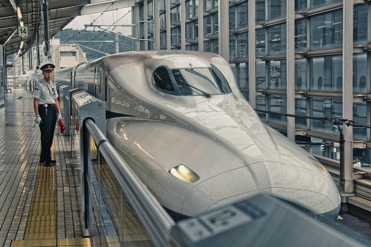 A sleek modern high-speed train traveling through the Italian countryside.