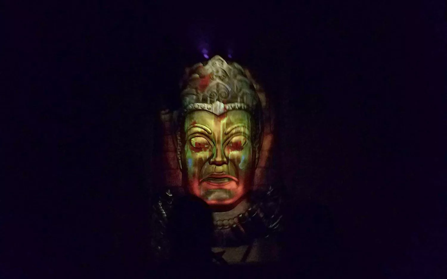 Crowds of guests walking through a sunny Disneyland thoroughfare near popular attractions.