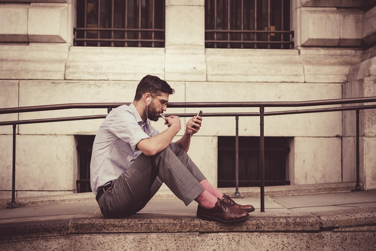 A traveler using a smartphone app on a city street to check for updates.