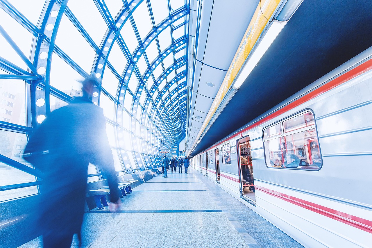 A clean, modern metro station in Barcelona showing an elevator and accessible platform.