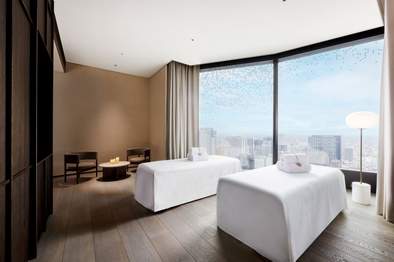 Serene spa treatment room with soft lighting and minimalist furniture.