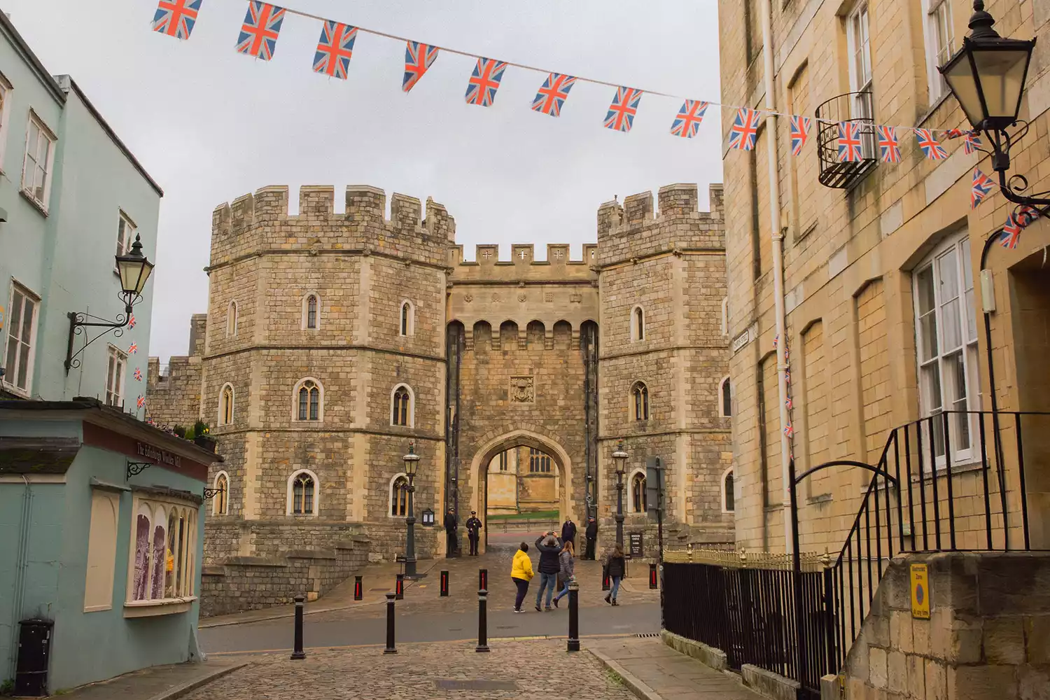A street-level view looking toward the historic stone walls of Windsor Castle.
