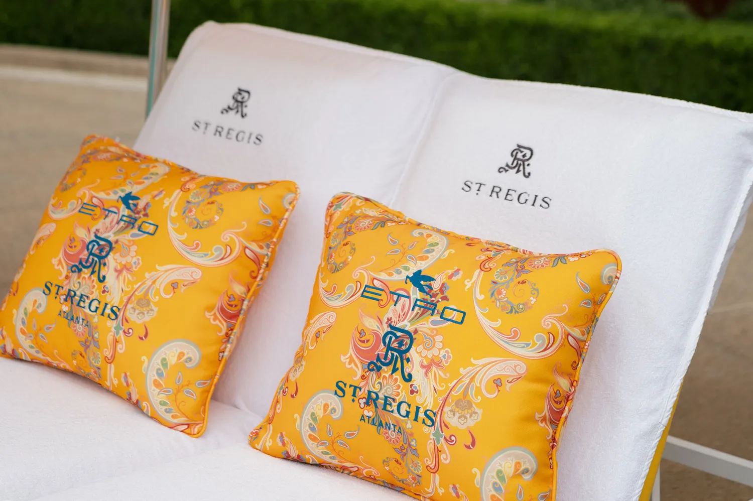 Close-up of embroidered cushions featuring the St. Regis and Etro branding.