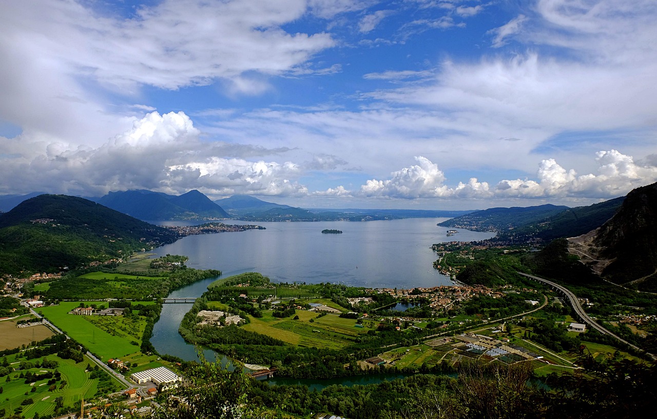 A wide view of Lake Maggiore with the Borromean Islands and the Alps in the background.
