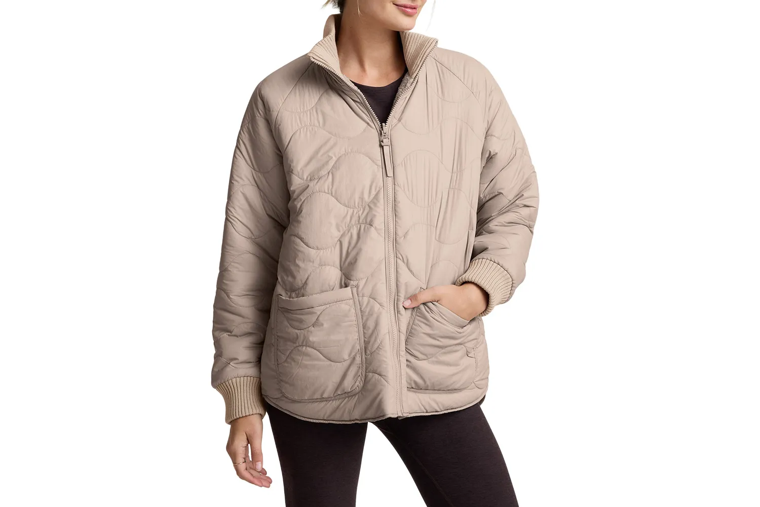 A woman wearing a 2-way quilted jacket showcasing a minimalist design.