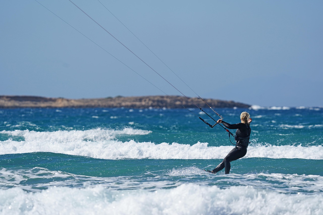 A woman surfing a wave wearing a stylish long-sleeve floral rash guard swimsuit.