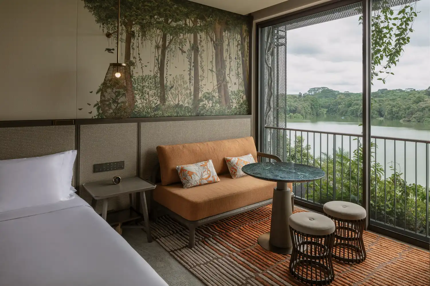 A Sanctuary King suite at Mandai Rainforest Resort in Singapore with forest-themed decor and views of lush greenery.