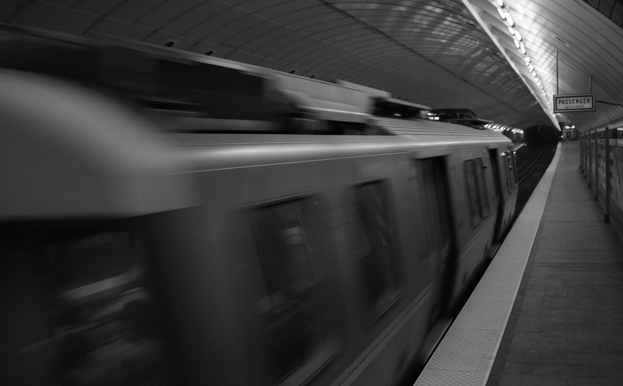 A Boston 'T' subway train arriving at an outdoor station platform.