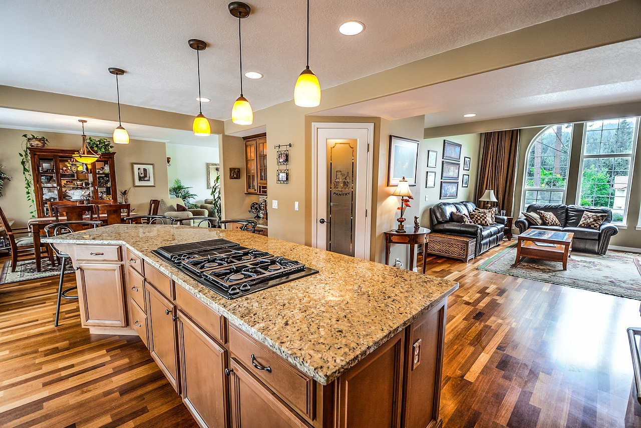 A high-end kitchen with white quartz countertops and rustic wooden beams in a luxury rental.