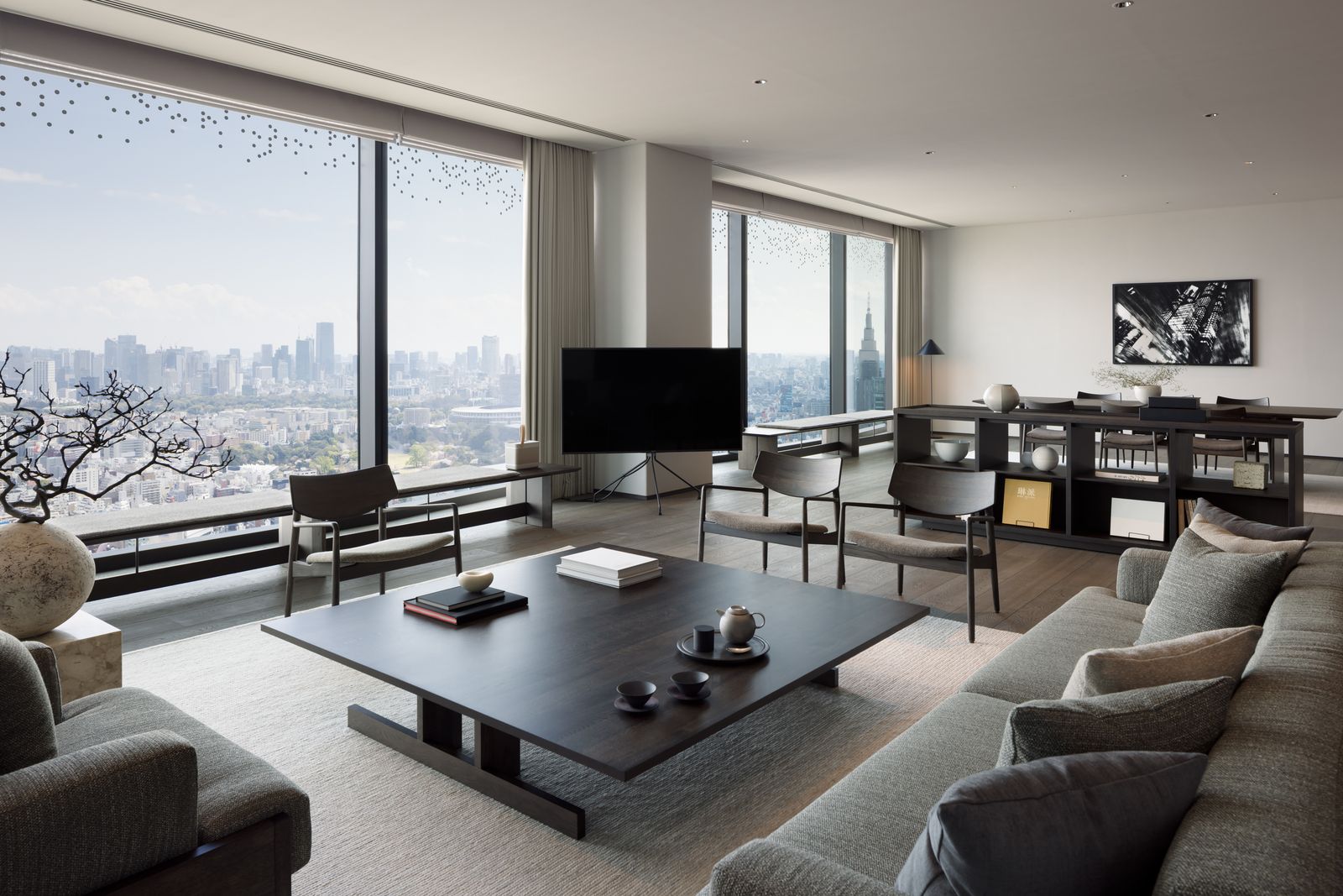 Interior of a luxury suite at Bellustar Tokyo with large floor-to-ceiling windows and minimalist decor.