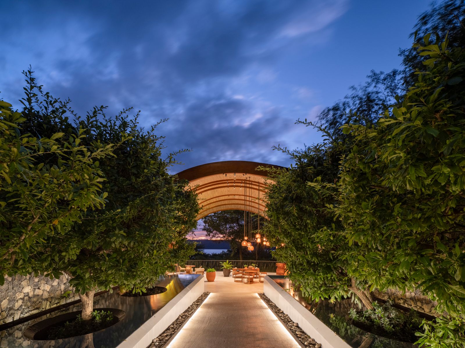 A luxury terrace and garden area overlooking a lush, hilly landscape at a Guanacaste resort.