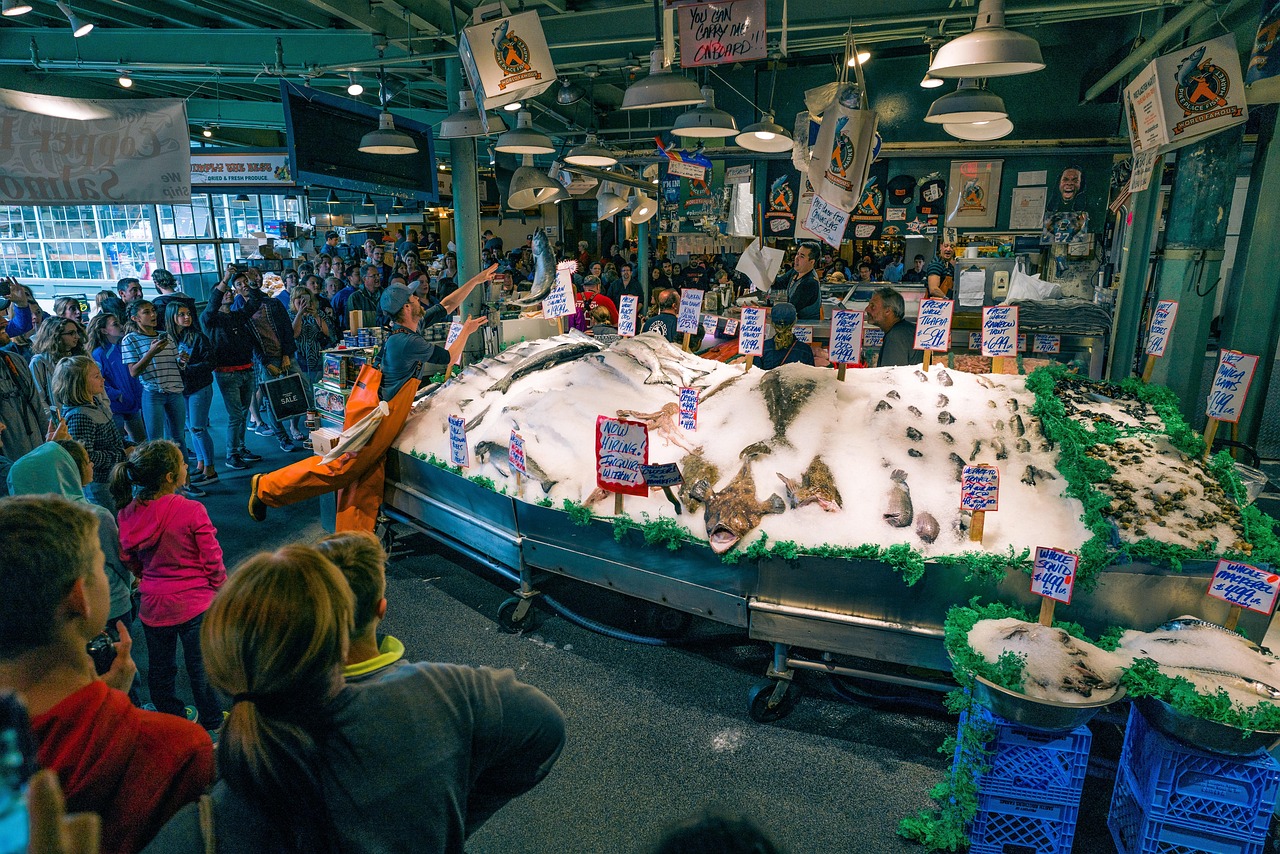 The iconic Pike Place Market sign with flowers in the foreground.