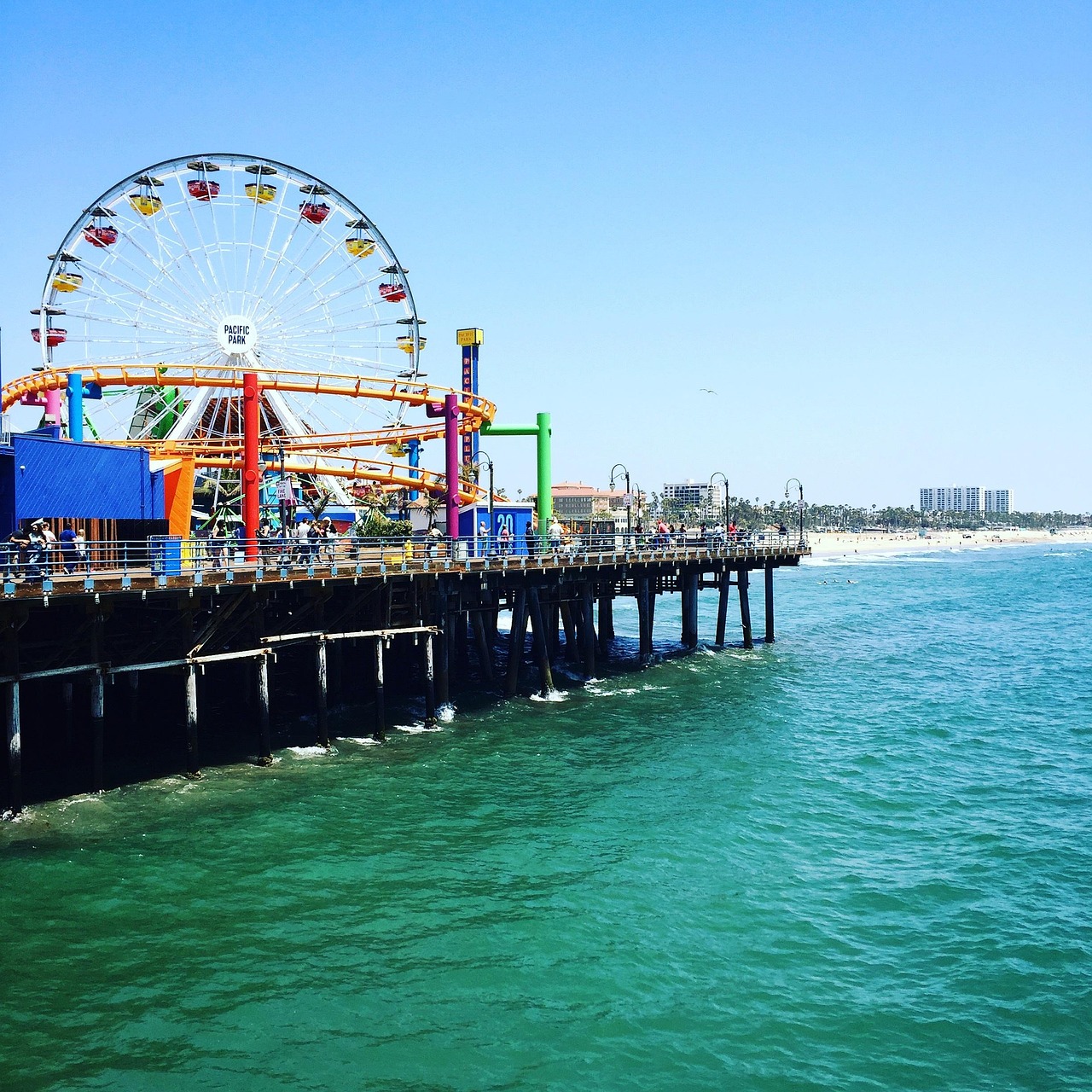 The iconic Pacific Park ferris wheel at Santa Monica Pier during a sunny day.