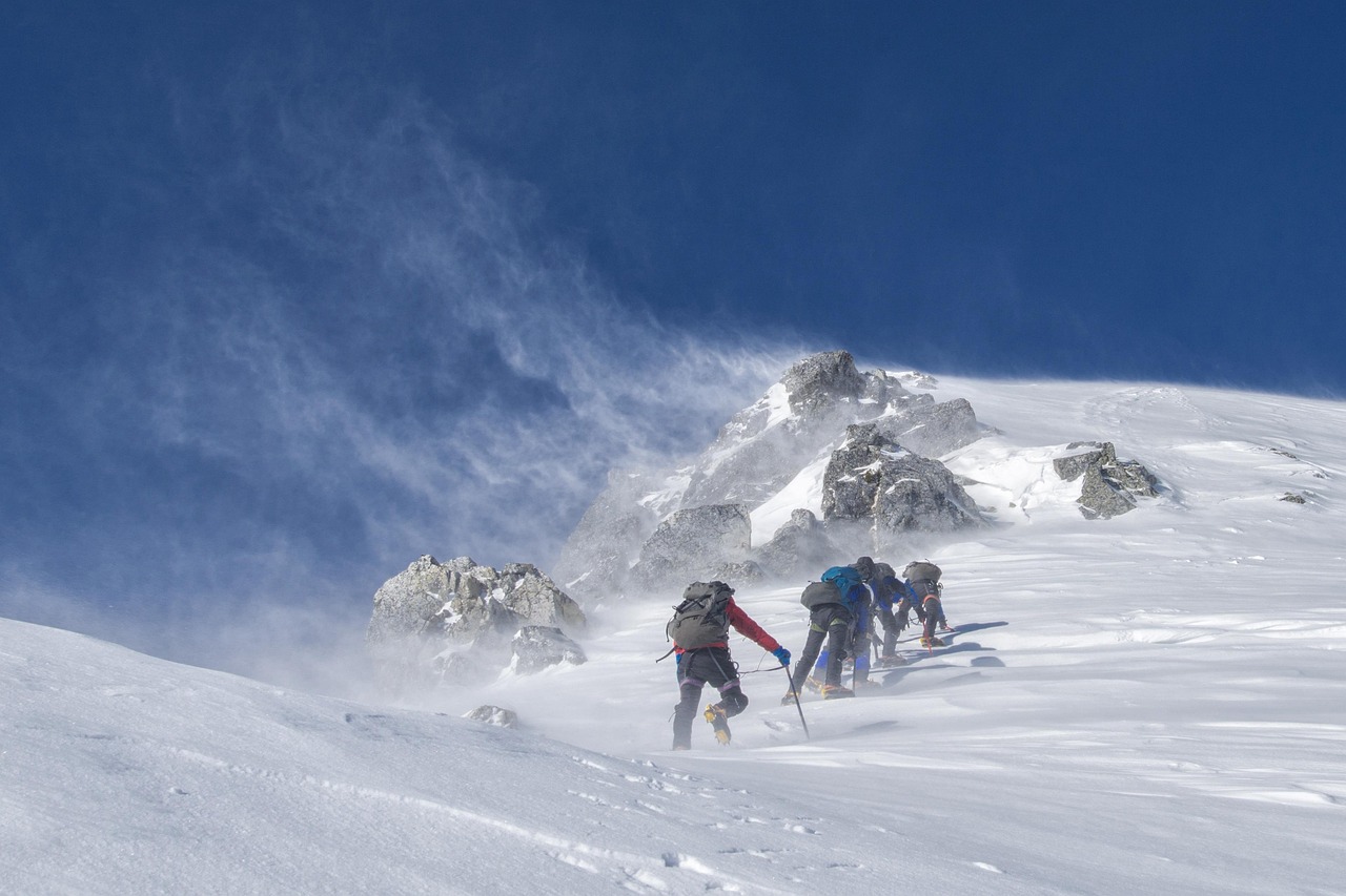 Sharp granitic mountain spires rising vertically into a clear blue sky.