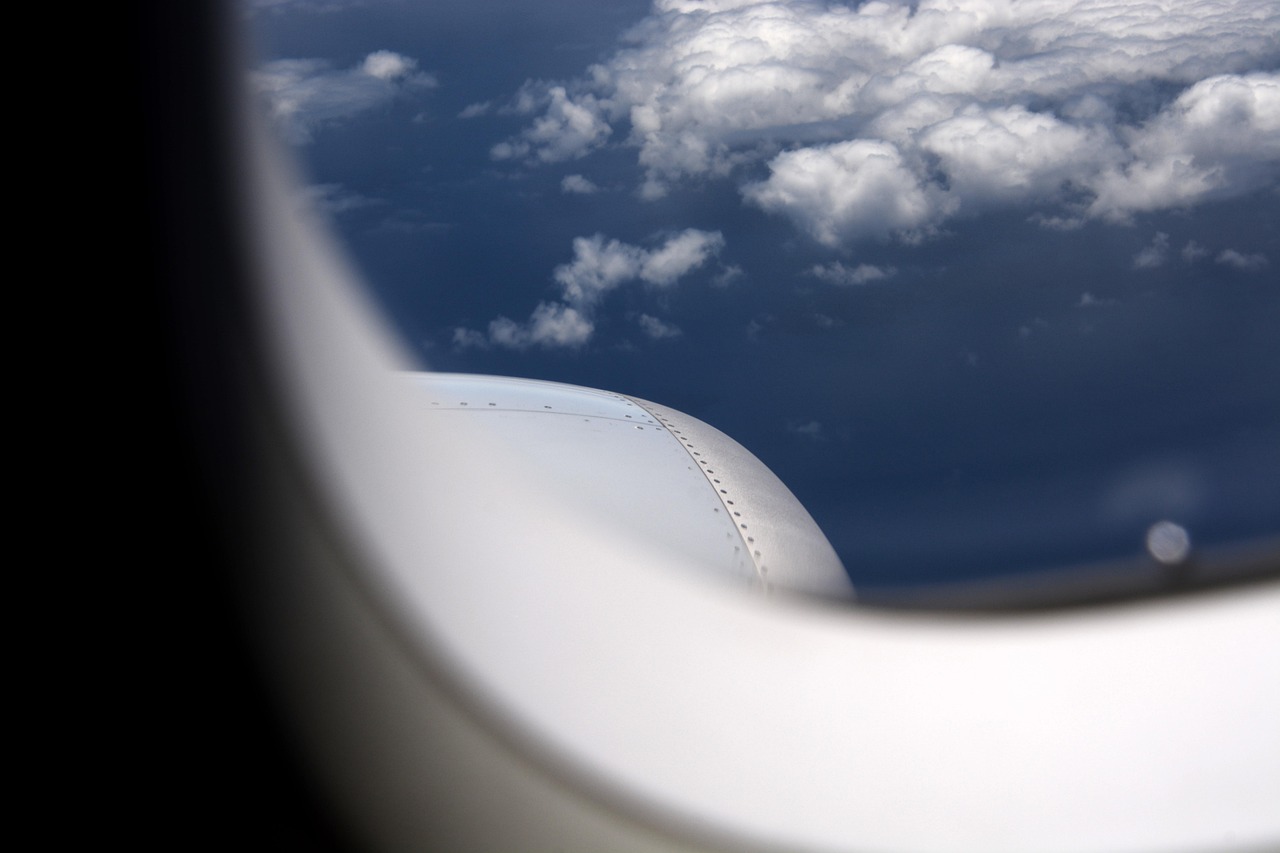 A modern and luxurious business class airplane cabin seat with plenty of legroom.