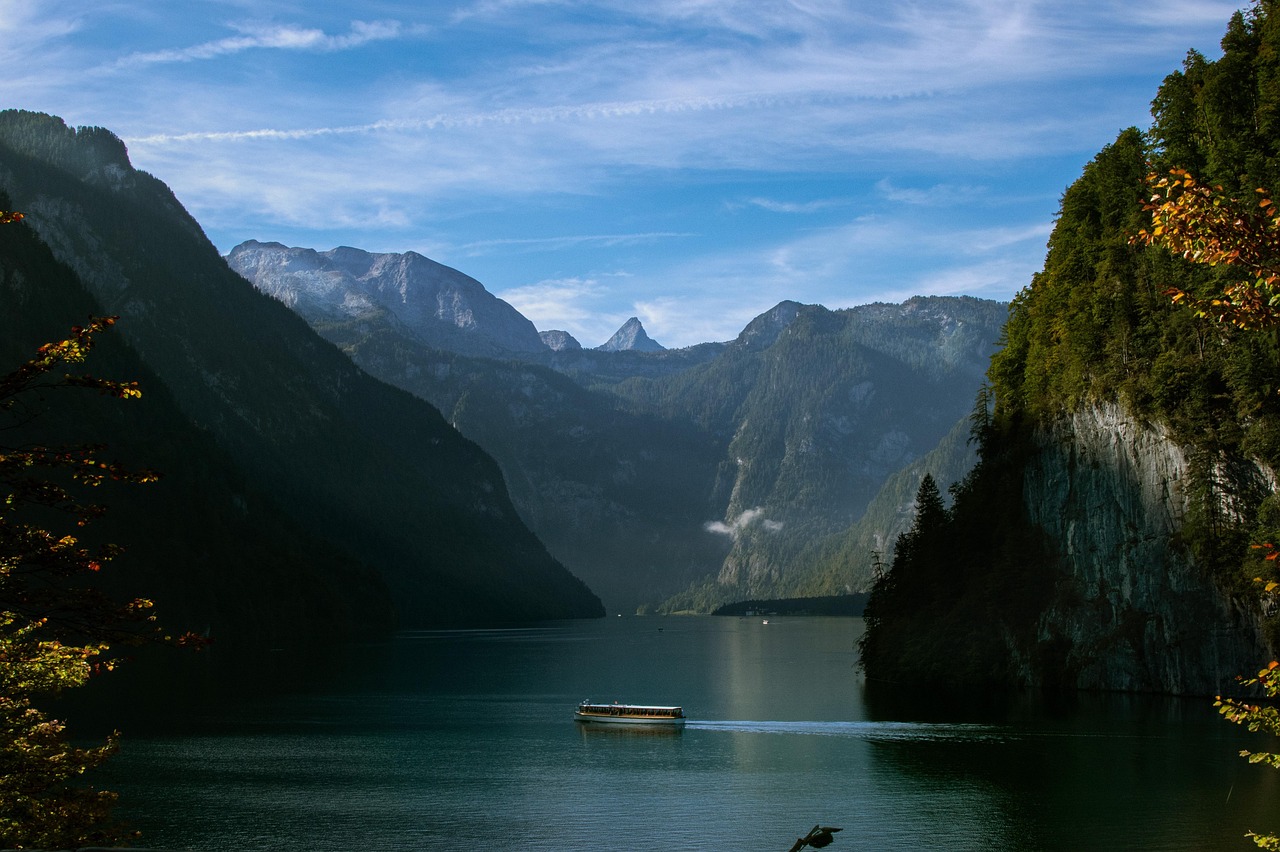 A serene European landscape in autumn with colorful trees and a quiet lake.