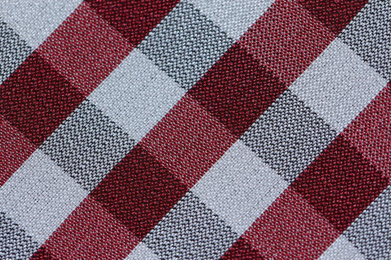 Close-up detail of high-thread-count white cotton fabric texture.
