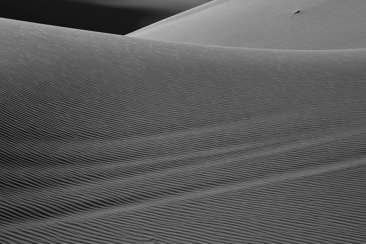 Wide angle view of white sand dunes under a clear blue sky