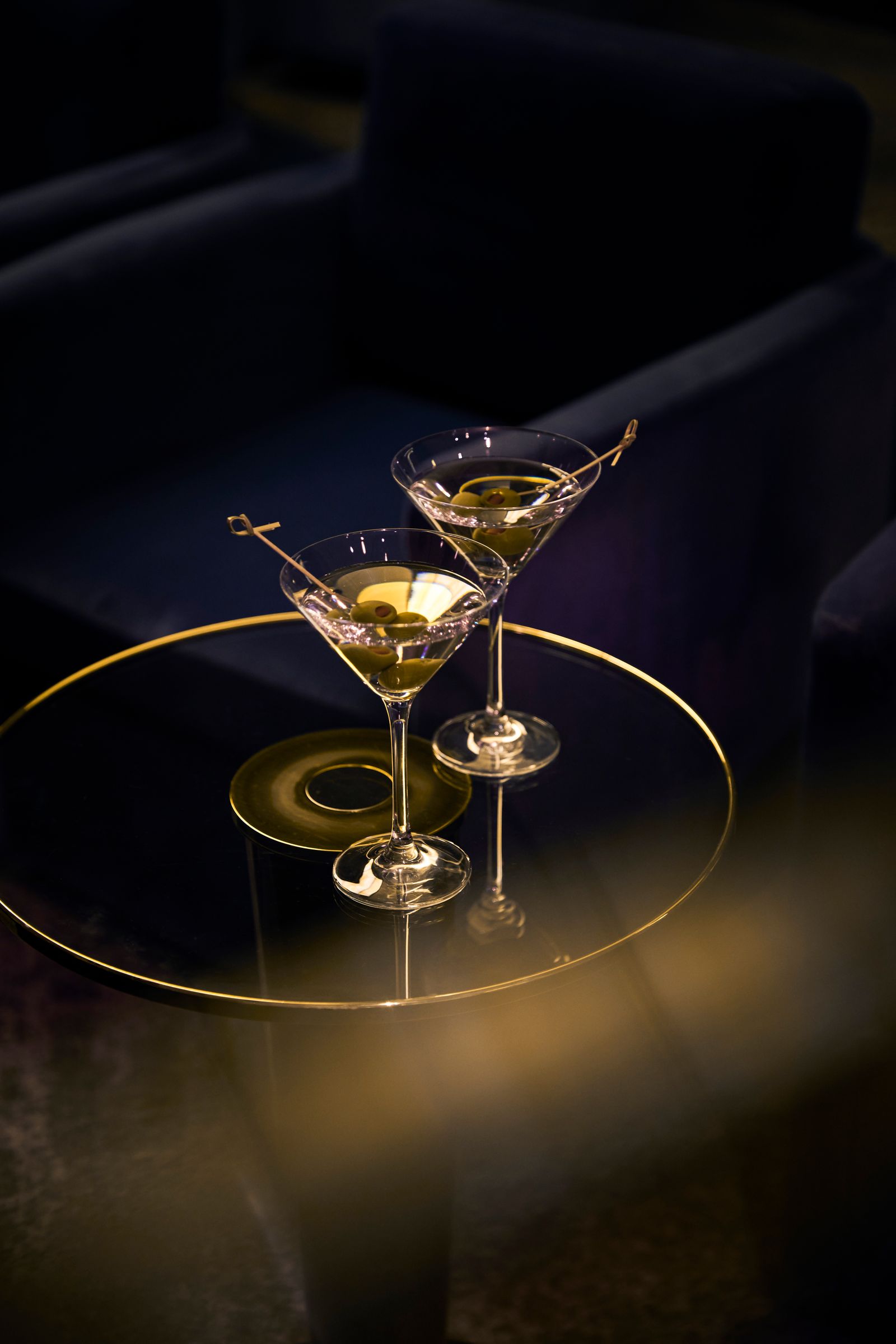Martini cocktails and elegant glassware on a cruise ship bar table.